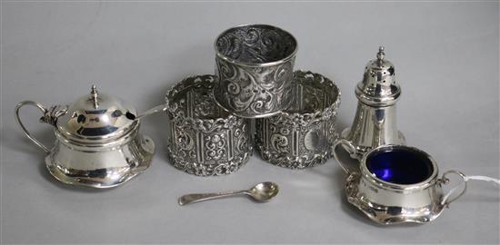 A pair of Edwardian silver napkin rings, Josiah Williams & Co, London, 1902, an earlier silver napkin ring & condiment set.